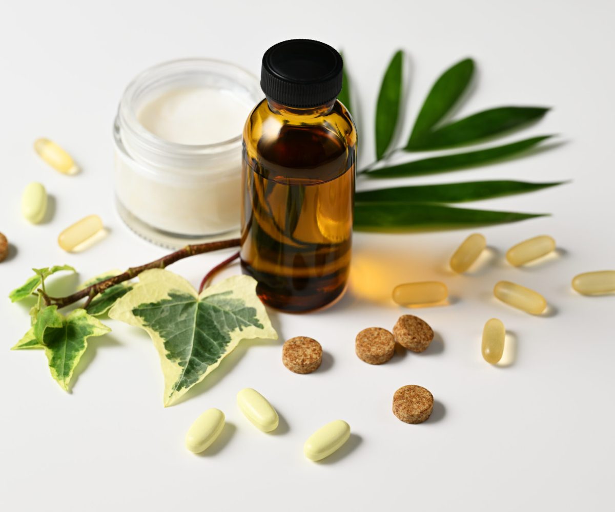 Arrangement of herbal lotion, cream and organic pills closeup