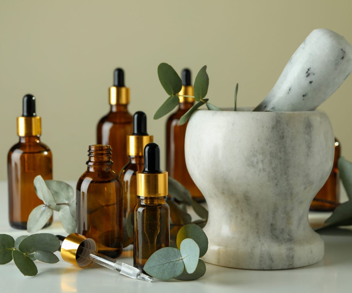 Concept of natural cosmetics with eucalyptus oil on white table