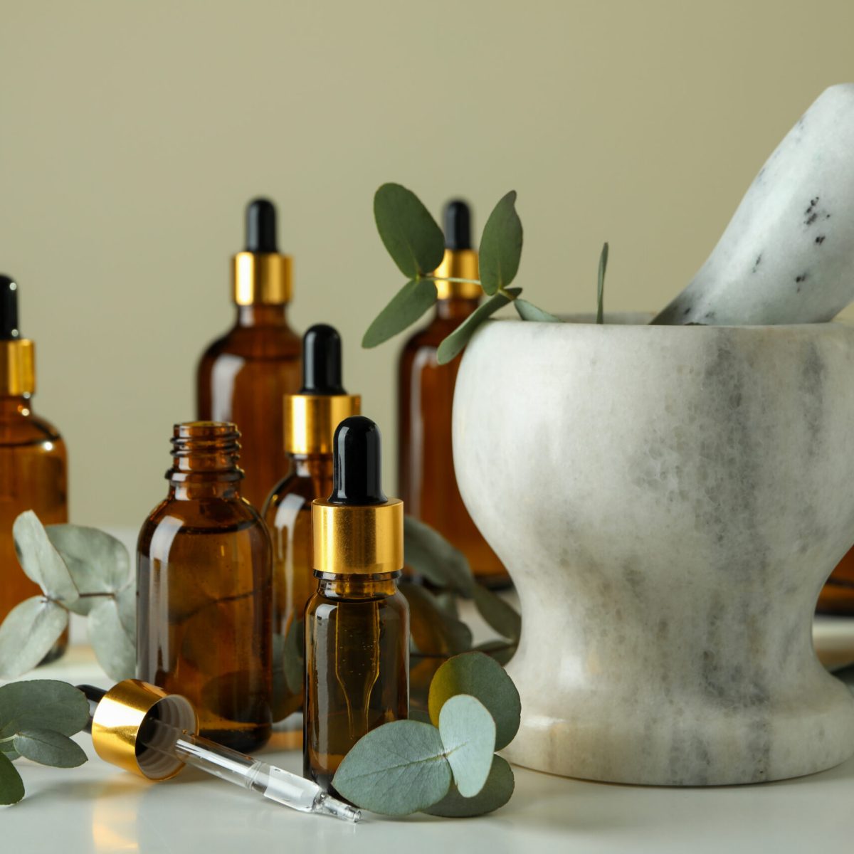 Concept of natural cosmetics with eucalyptus oil on white table
